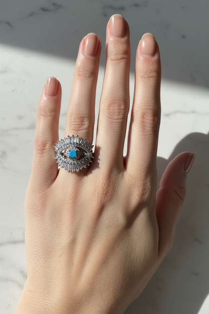 UGC lifestyle shot of silver baguette evil eye ring worn on woman's hand