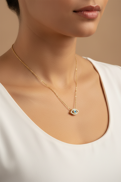 Woman wearing gold evil eye zirconia necklace on collarbone