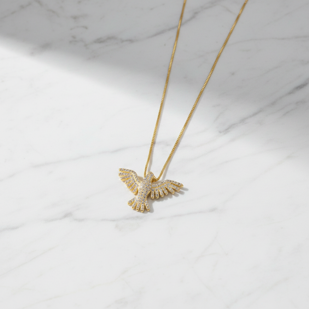 Pavé CZ eagle necklace flat lay on marble