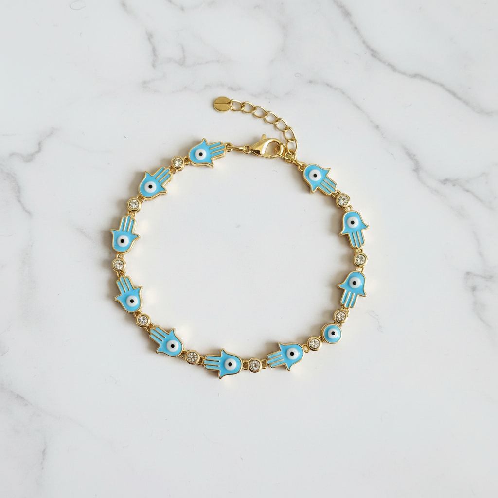Blue hamsa evil eye bracelet on white marble