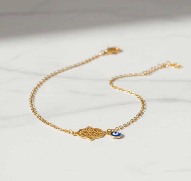 Hamsa evil eye anklet on marble flat lay