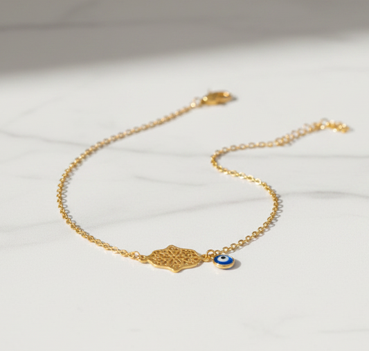 Hamsa evil eye anklet on marble flat lay