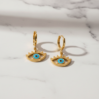 The Guardian Eye Earrings on white marble