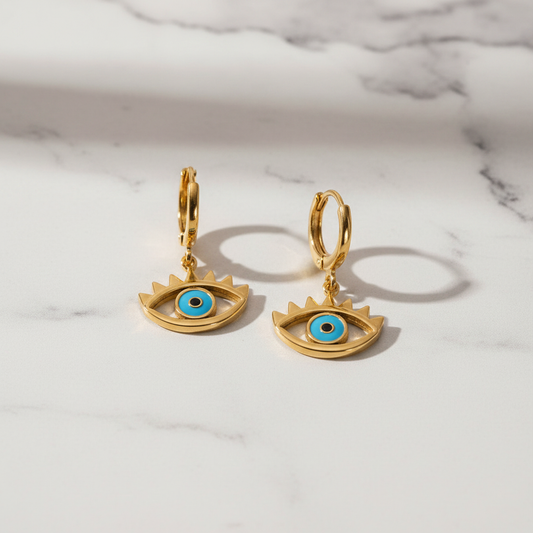 The Guardian Eye Earrings on white marble