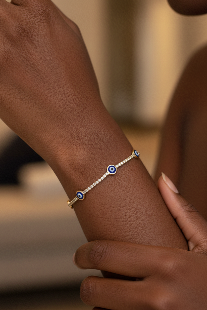 UGC lifestyle shot of gold evil eye tennis bracelet worn on dark skinned woman's wrist