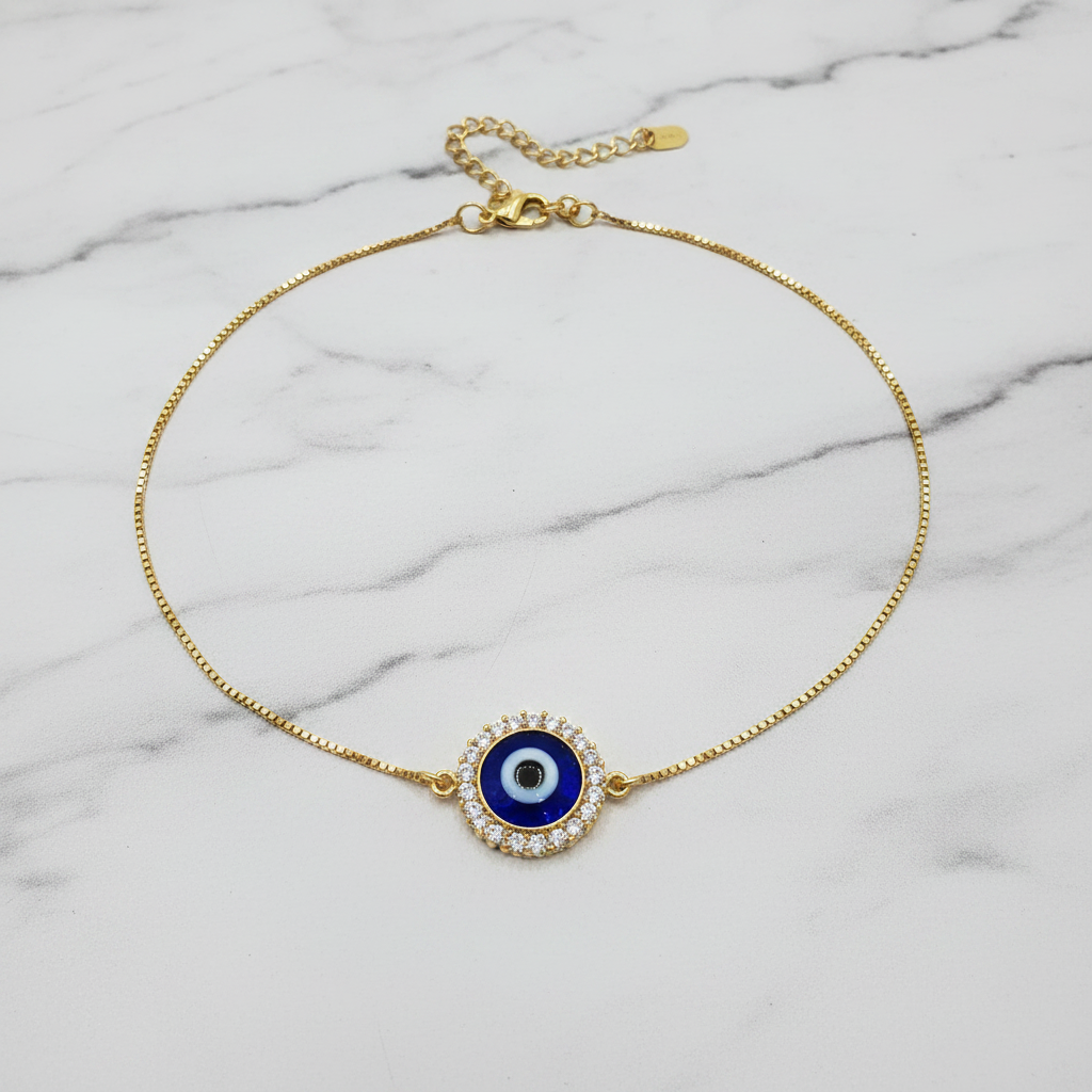 CZ evil eye halo anklet flat lay on marble