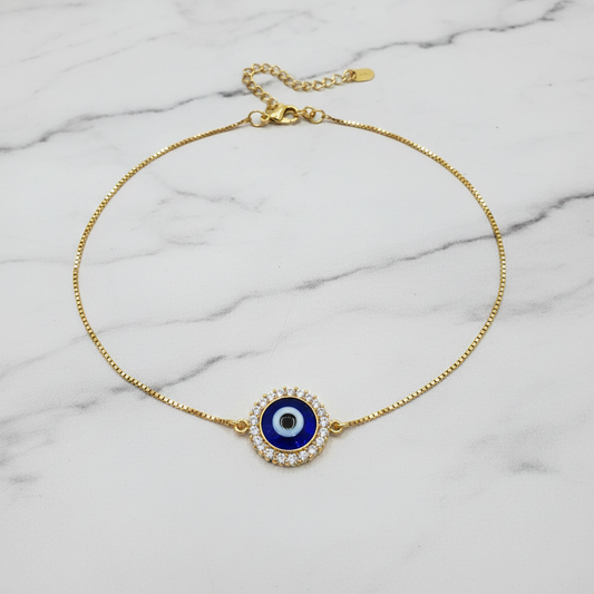 CZ evil eye halo anklet flat lay on marble