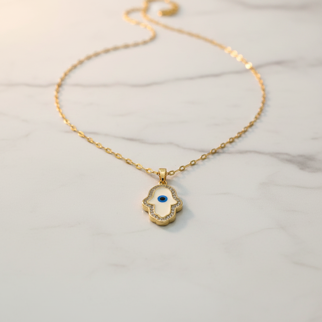White enamel Hamsa evil eye necklace product shot on white marble