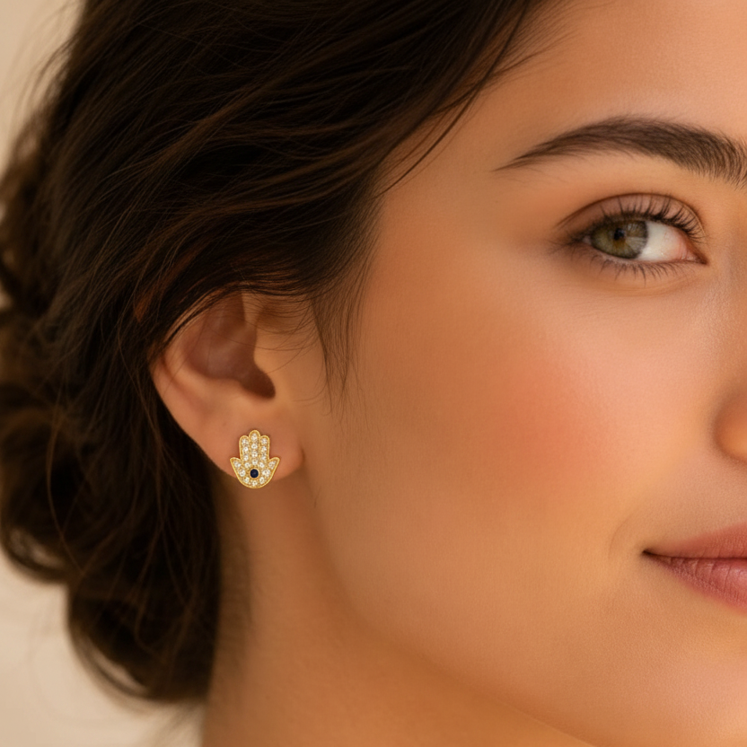 Close-up of model wearing Hamsa gold stud earring