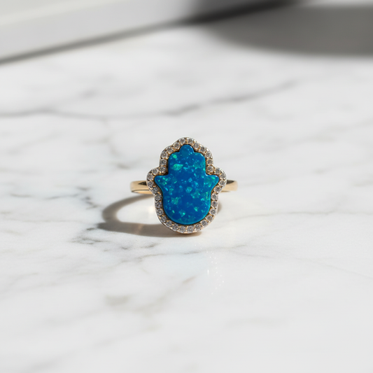 Blue opal hamsa ring flat lay marble dramatic lighting