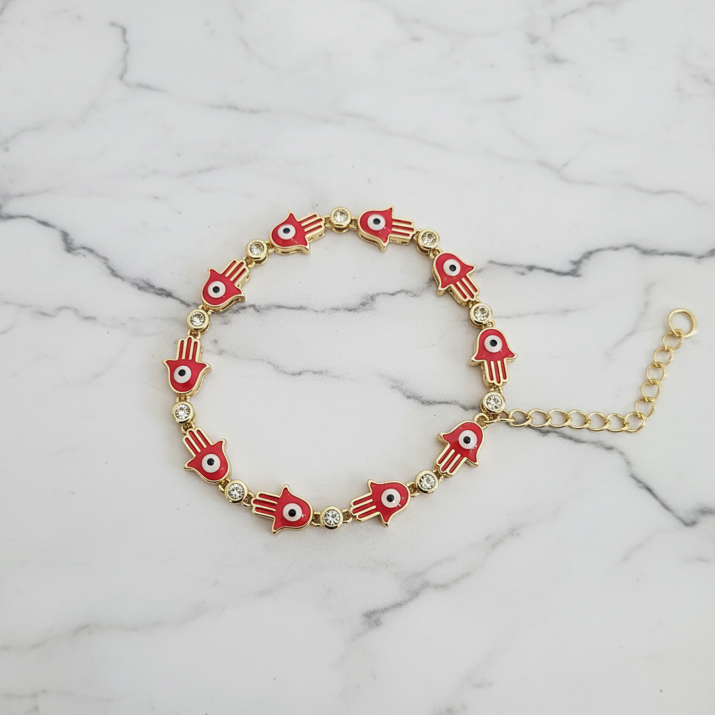 Red hamsa evil eye bracelet on white marble