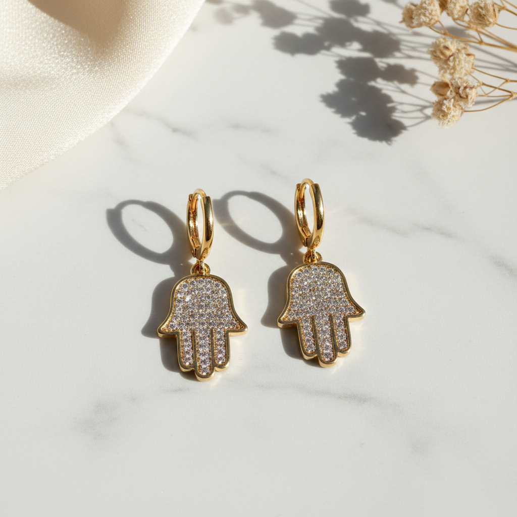 The Hamsa Hoop Earrings on white marble