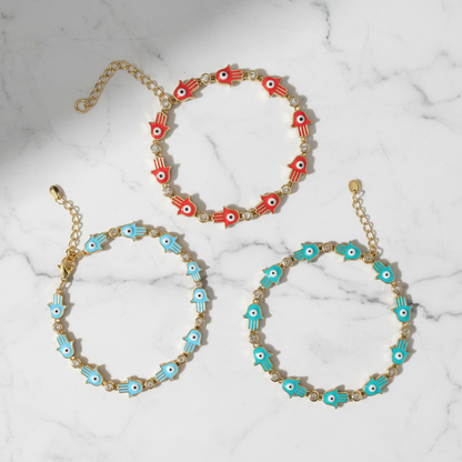 Three hamsa evil eye bracelets in red and turquoise on white background