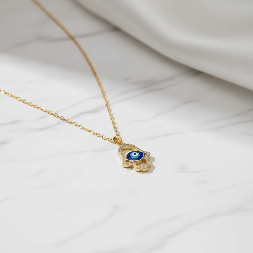 Hamsa Evil Eye Pendant Necklace on white marble background