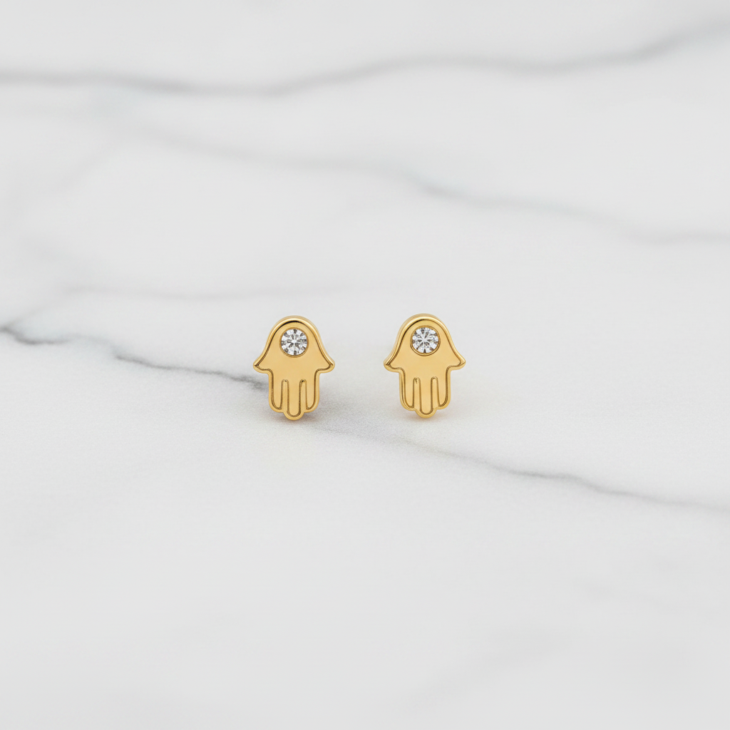 Hamsa hand stud earrings on white marble