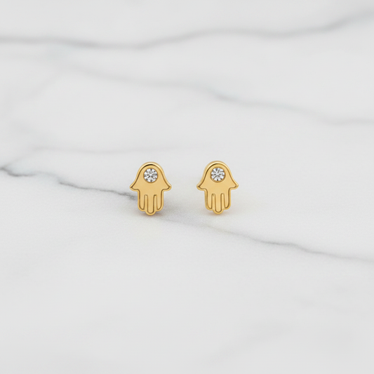 Hamsa hand stud earrings on white marble