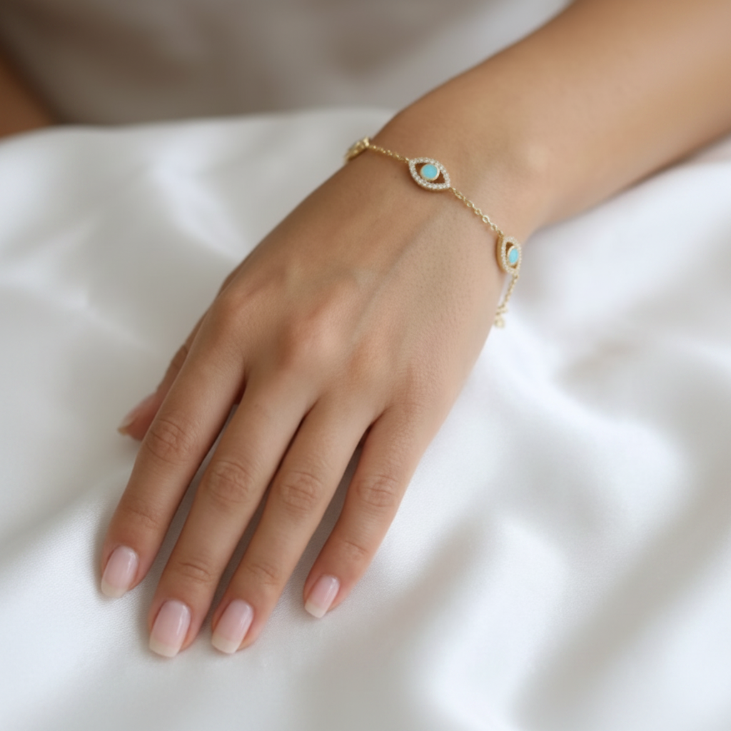 Nazar Station Bracelet worn on model wrist - blue variant on white satin