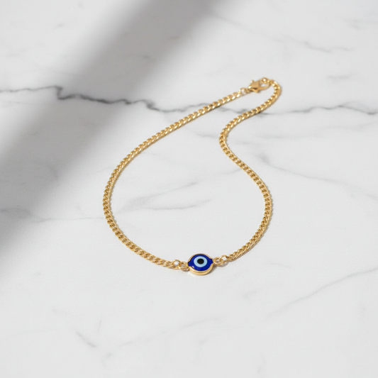 Evil eye curb chain anklet flat lay on marble