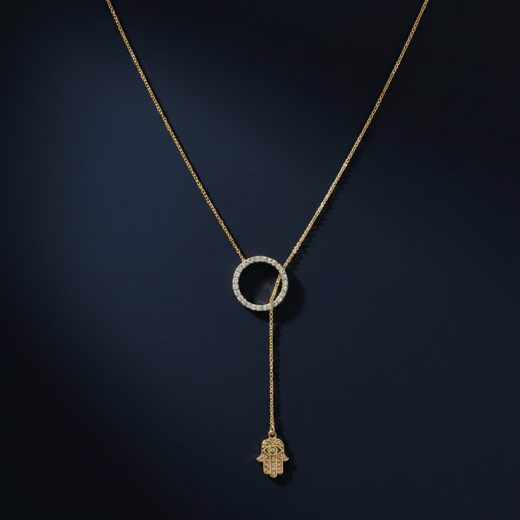 Gold hamsa lariat necklace on dark navy background