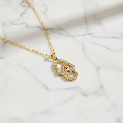 CZ Hamsa Evil Eye Necklace on marble background