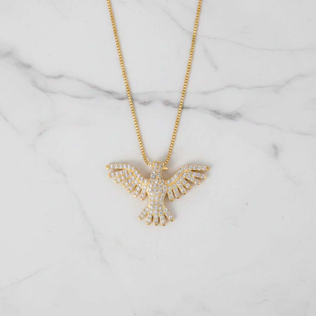Pavé CZ phoenix necklace flat lay on marble