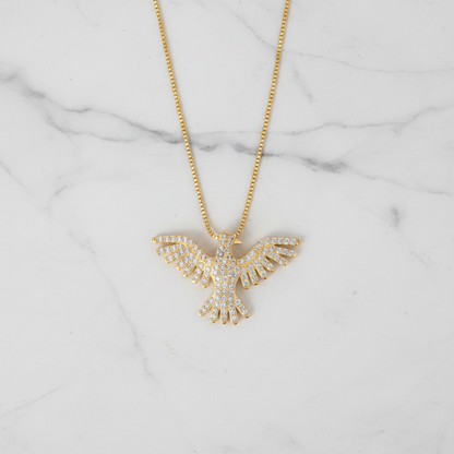 Pavé CZ phoenix necklace flat lay on marble