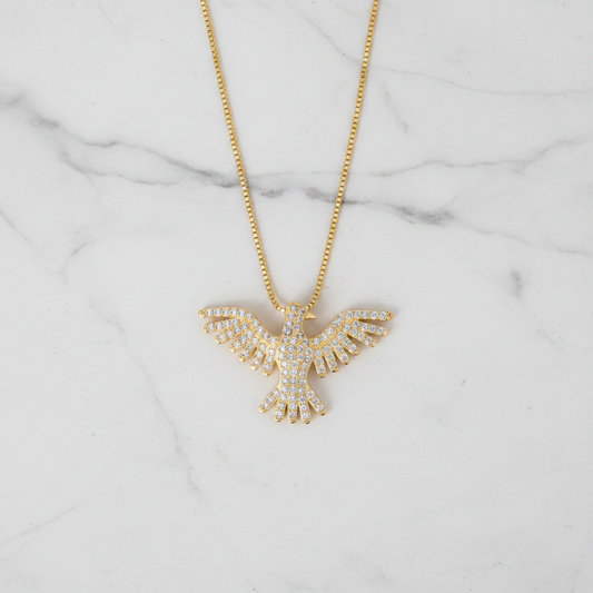 Pavé CZ phoenix necklace flat lay on marble