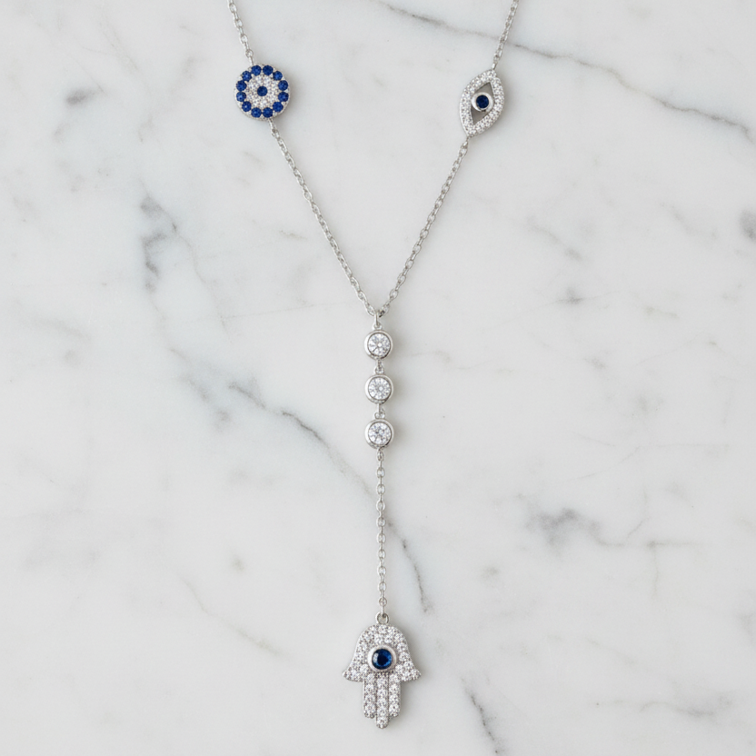The Guardian Lariat necklace on white Carrara marble background