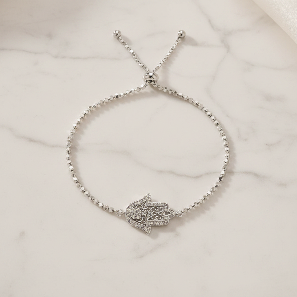 Hamsa Hand Bracelet on white marble background