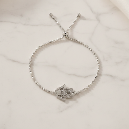 Hamsa Hand Bracelet on white marble background